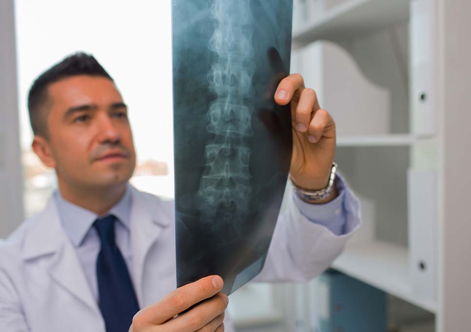 Doctor at Jupiter Disc Center examining patient x-rays for spine injury